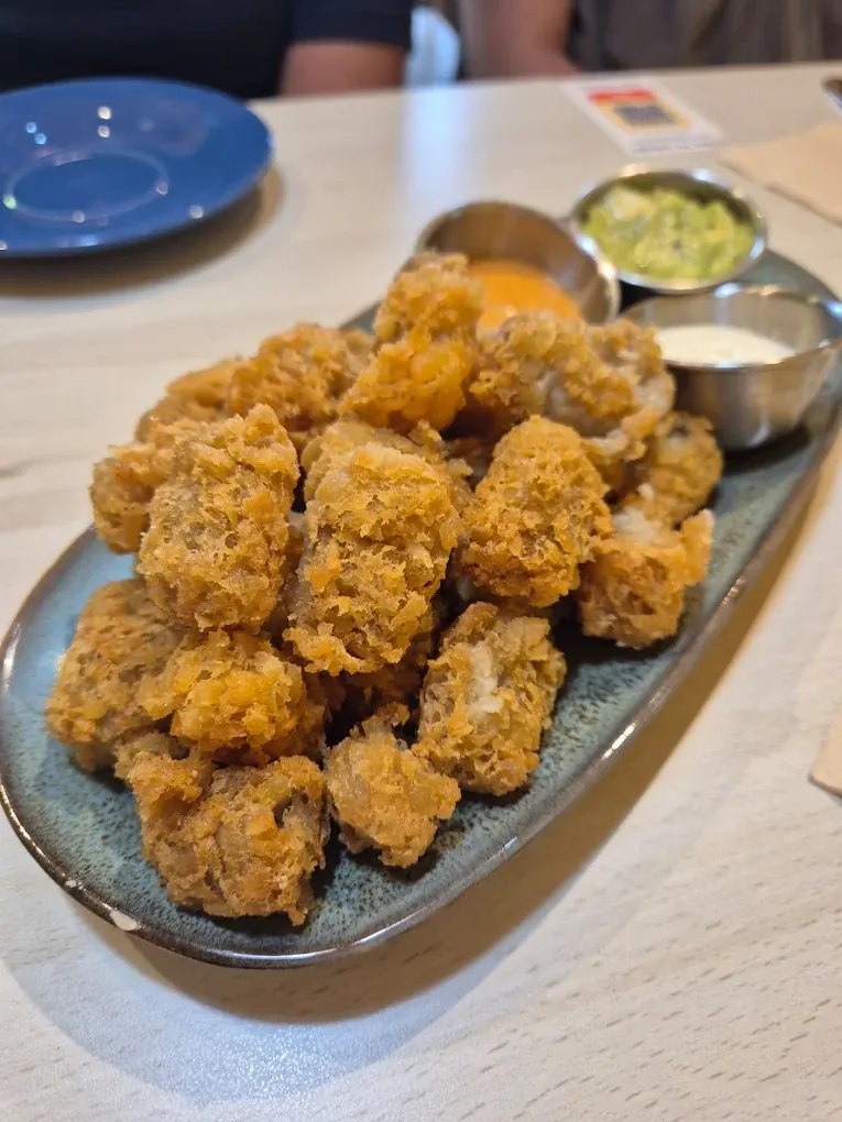 Crisp battered chicken bites served with chipotle mayonnaise, guacamole and sour cream